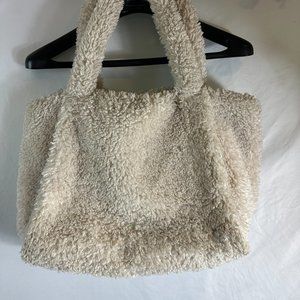 Fuzzy white bag with snap closure